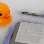 Kindle 3 floating in Trendy Digital case, with rubber duck looking on