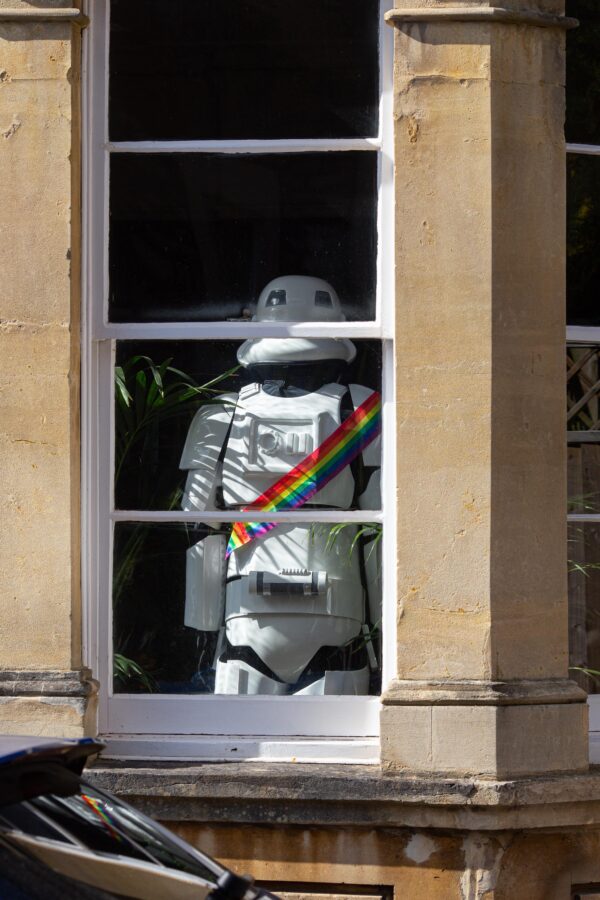 Storm trooper with rainbow bandolier, back turned to viewer, in the window of a Georgian house in Cliftonwood, Bristol